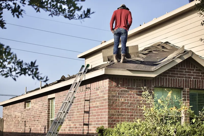 Professional roofer working on a residential roof in Perdew Island